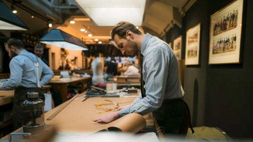A tailor working in the cutting theatre at Huntsman on Savile Row.